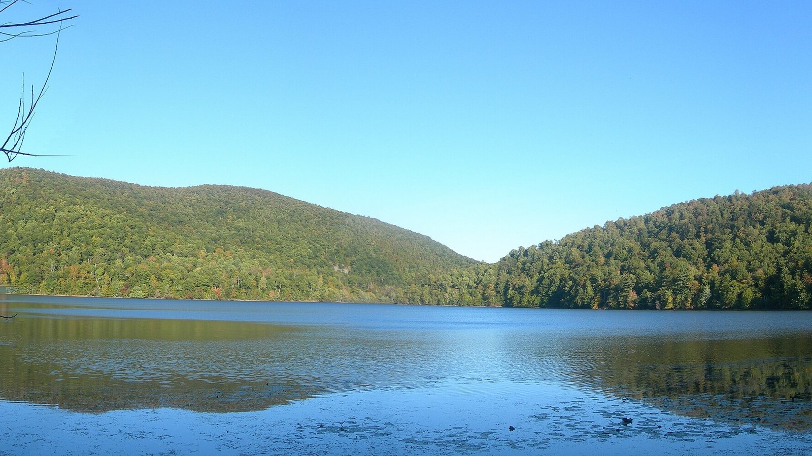 Lake Hertel surrounded by forested hills within the Gault Nature Reserve at Mont Saint-Hilaire, Quebec
