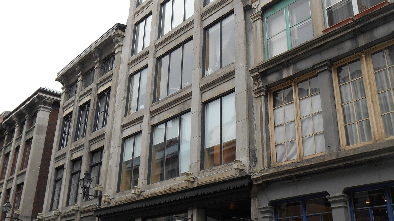 A historic greystone building on Rue Saint-Paul, Old Montreal's oldest street
