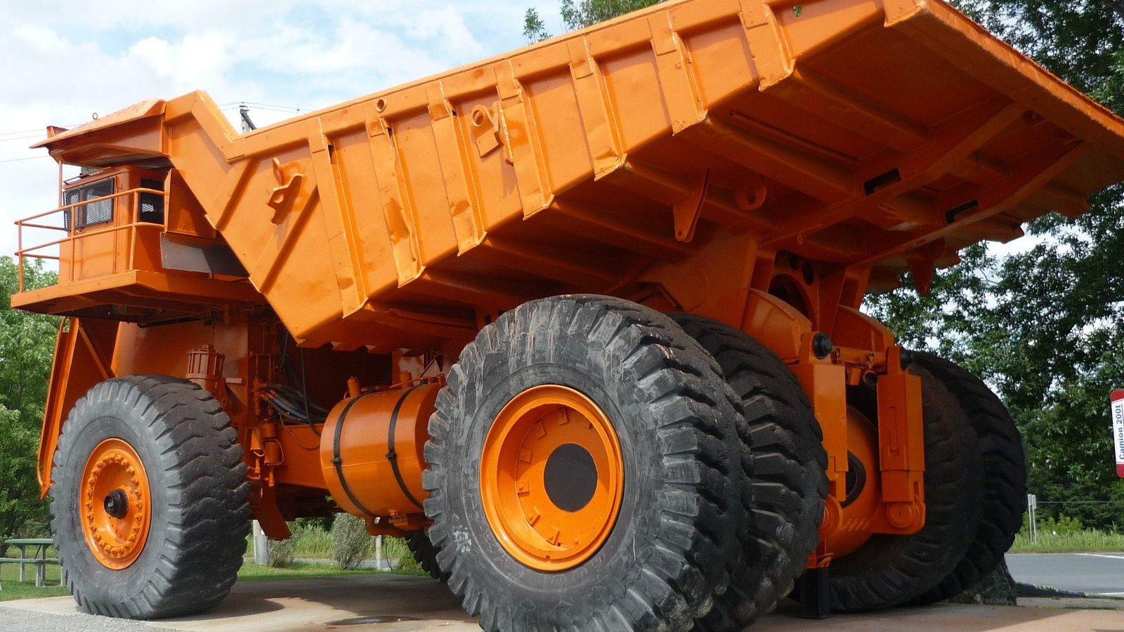 A giant retired mining truck with oversized tires, displayed in Val-des-Sources (formerly Asbestos), Quebec, from the historic Jeffrey Mine